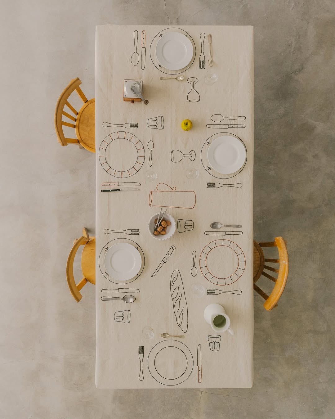 A long table prepared with place settings for women to gather